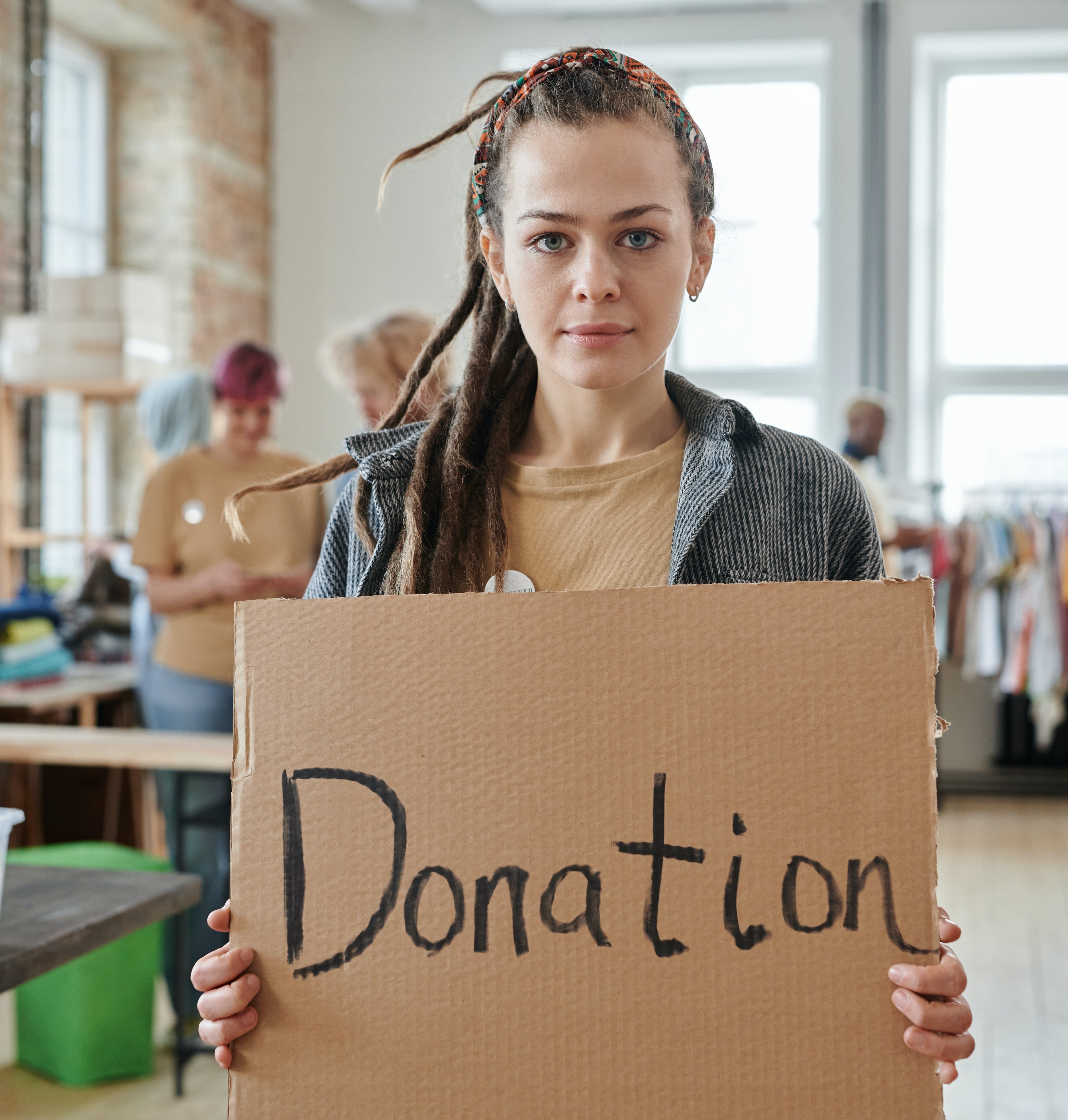 Woman holding a donation sign made of cardboard
