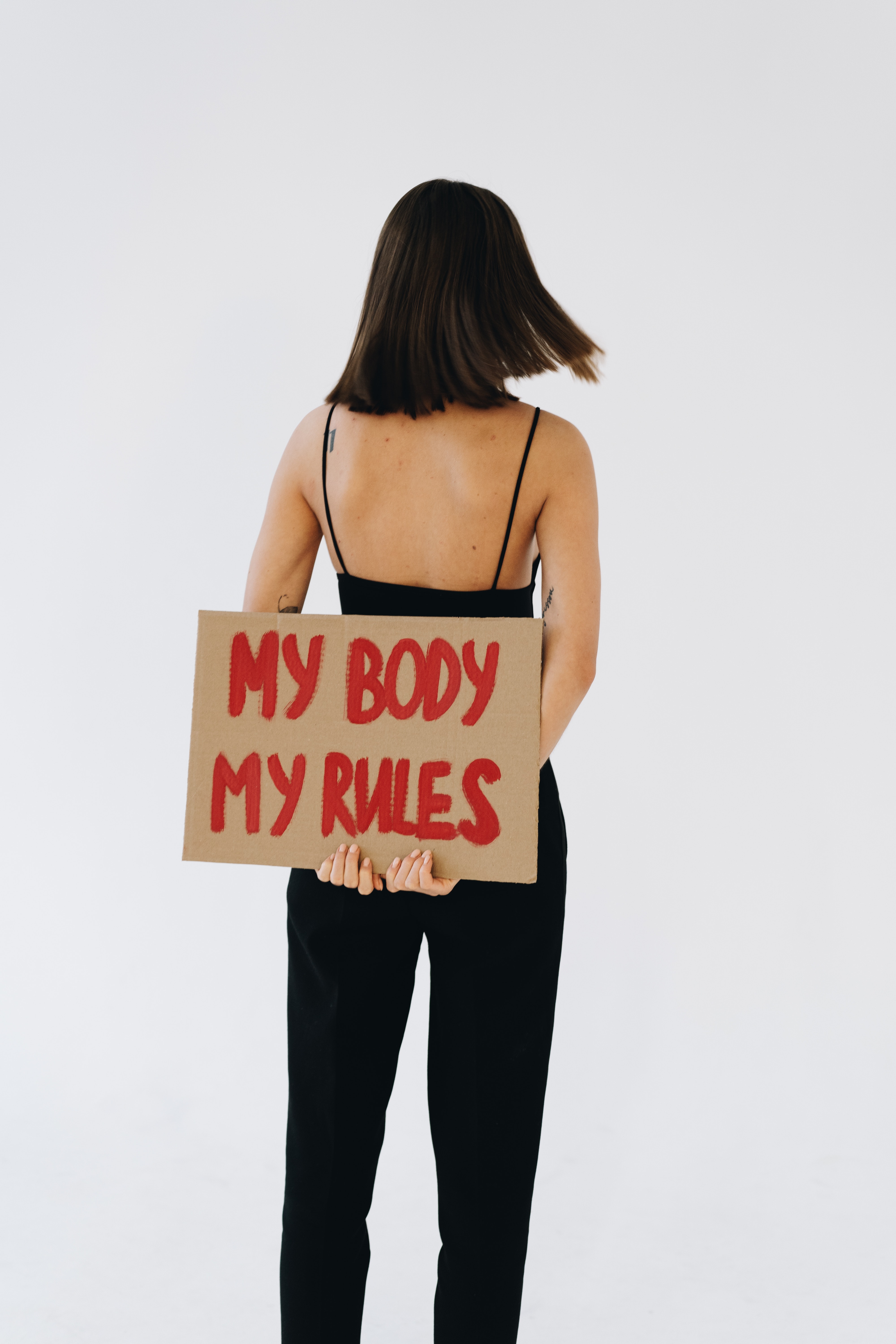 woman holding sign that reads 